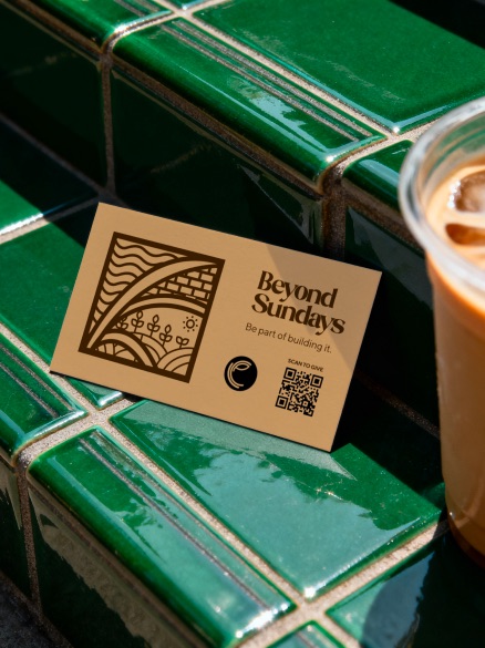 Beyond Sundays card on green tile beside a drink