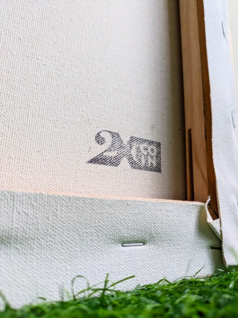 Close-up of a canvas back with a 2XCOIN stamp