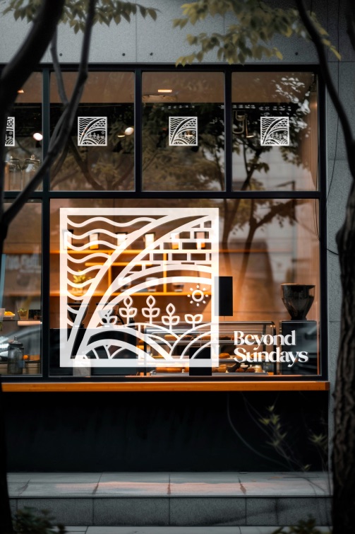 Shop window with the Beyond Sundays mark in white