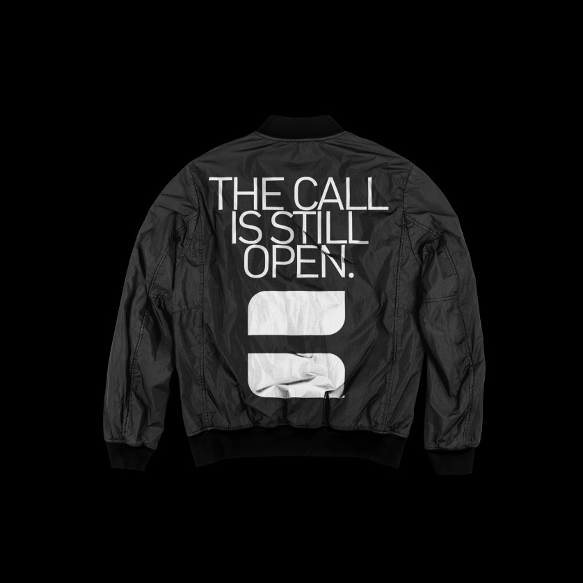 Black bomber jacket printed THE CALL IS STILL OPEN
