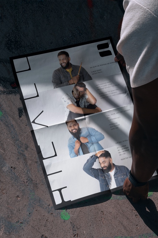Folded Hicall poster held over a concrete floor